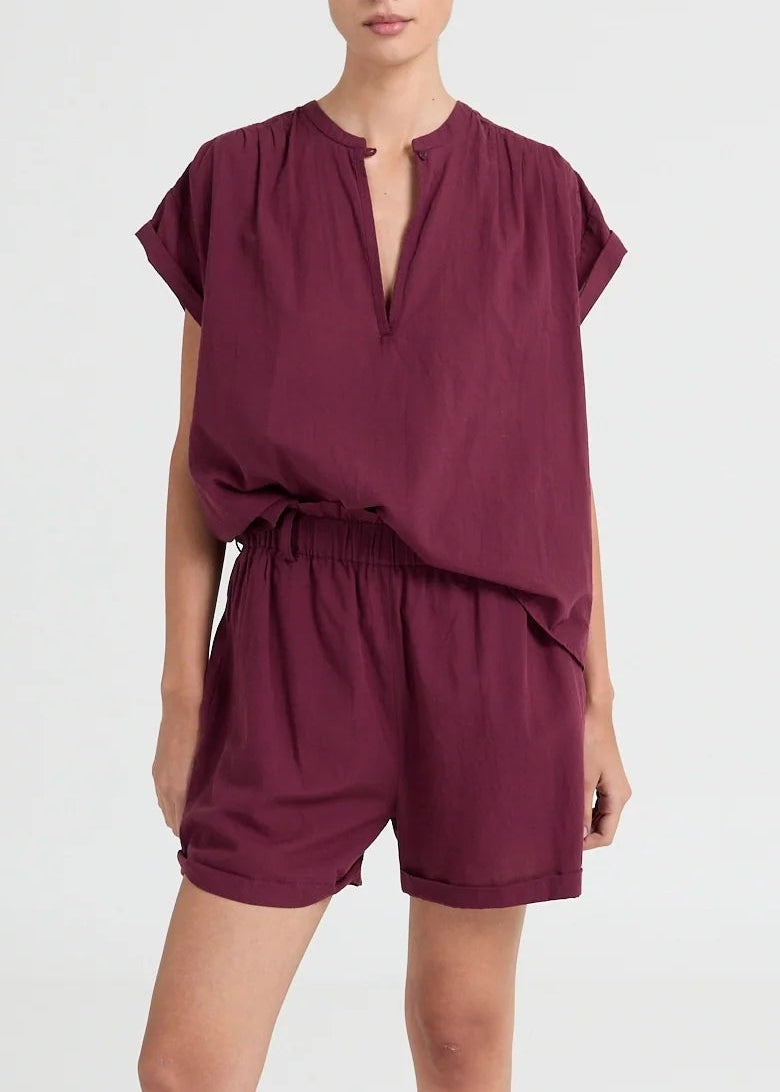 Lightweight blouse featuring a subtle V-neck and fluid drape. An understated essential with a modern, relaxed fit.