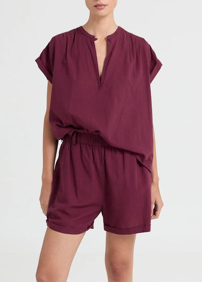 Lightweight blouse featuring a subtle V-neck and fluid drape. An understated essential with a modern, relaxed fit.