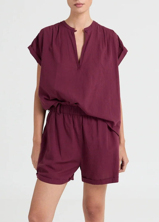 Lightweight blouse featuring a subtle V-neck and fluid drape. An understated essential with a modern, relaxed fit.